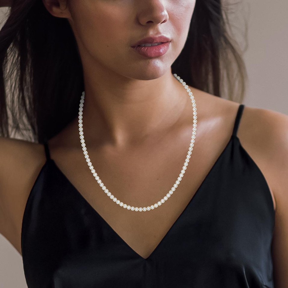 Experience timeless sparkle with this 19.25 carat round diamond tennis necklace, featuring 0.25 pointer diamonds. Choose lab-grown for sustainable brilliance.